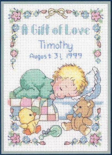 Cross-stitch birth sampler chart with a sleeping baby, teddy bear, duck, and other toys