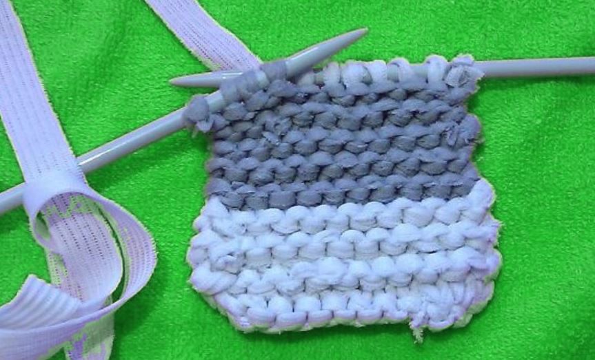 Striped washcloth piece on knitting needles