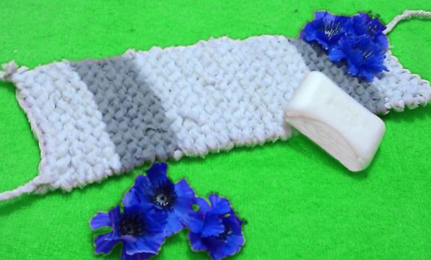 Finished striped knitted washcloth with two handles