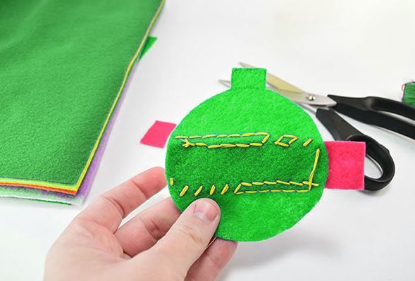 Back of a circular felt cat toy with stitching