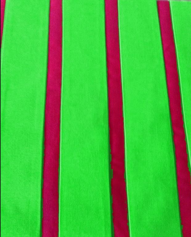 Raspberry ribbons sewn onto green bag fabric