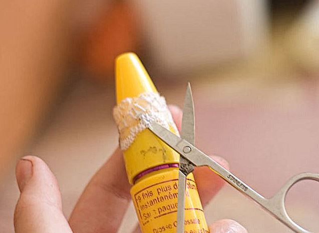 Trimming the lace ring on a yellow tube with scissors