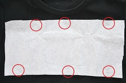 Securing the paper and appliqué with pins before sewing