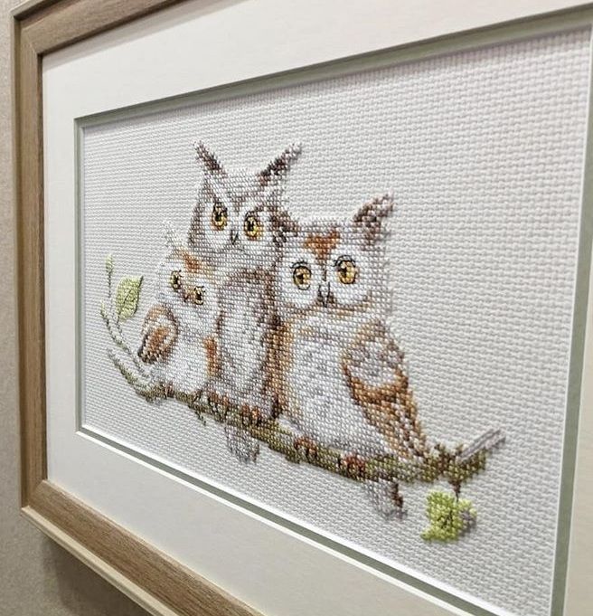 Framed miniature embroidery of two owls on a branch