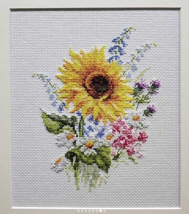 Miniature embroidery of a sunflower and wildflower bouquet