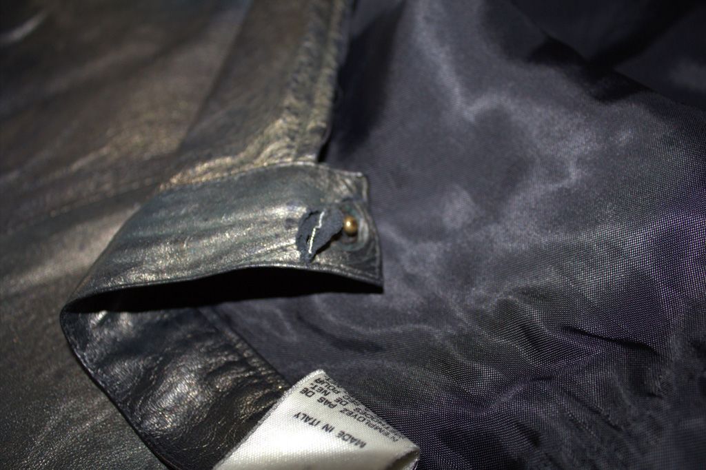 Close-up of metallic gold-green leather skirt waistband with split near snap