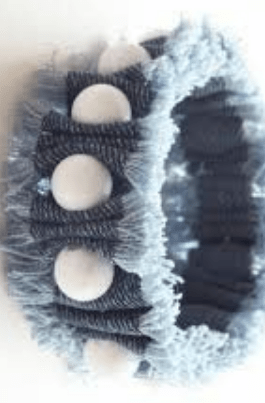 Finished single-strand denim bracelet on a wrist