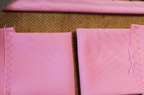 Two pink bow tie pieces with finished edges