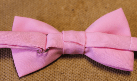 Back of the pink bow tie with the strap threaded through