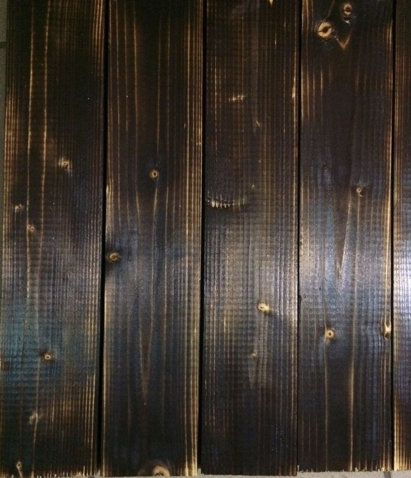 Burning the pine board with a torch