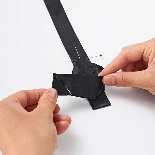 Forming a pleat from black satin ribbon