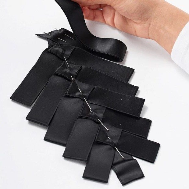 Finished plastron piece made of black pleats
