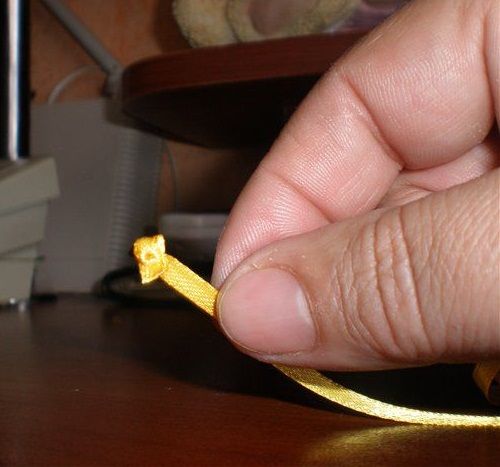 Оплавлений кінець стрічки після обробки запальничкою