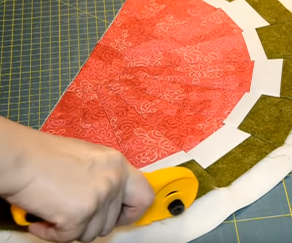 Trimming the edge of the hot pad with a rotary cutter