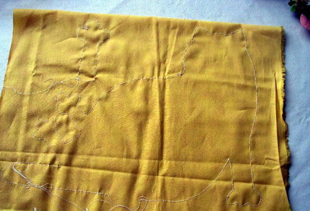 Cat outline stitched through two layers of yellow fabric