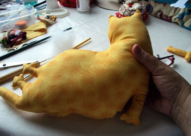 Stuffing the fabric cat doorstop piece
