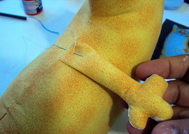 Sewing a paw onto the fabric cat doorstop