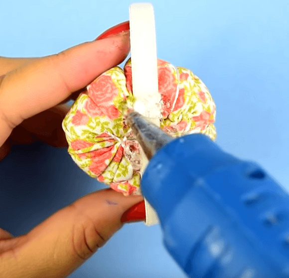 Gluing the elastic to the back of the pincushion