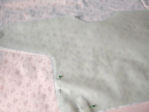 Cut fabric pieces for a baby wrap shirt