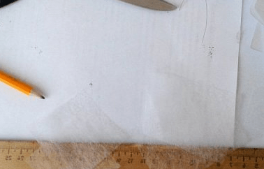 Outline of butterfly parts on light-colored fabric