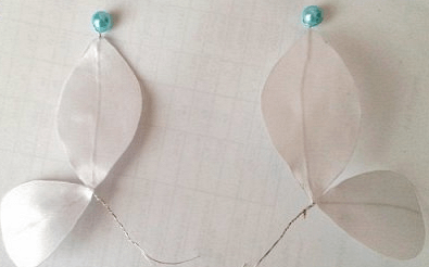 Nearly finished butterfly with white wings and beads