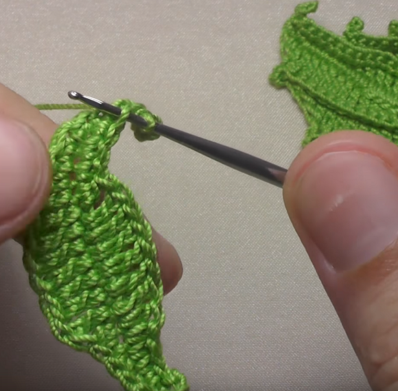 Crocheting the edge of a formed green leaf