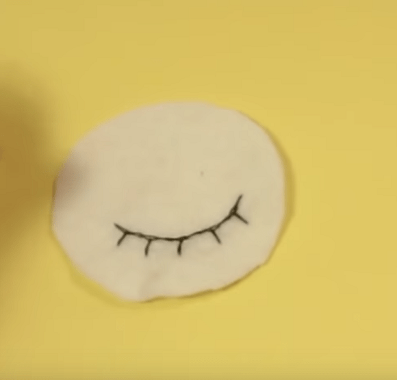 White felt eye piece with embroidered eyelashes