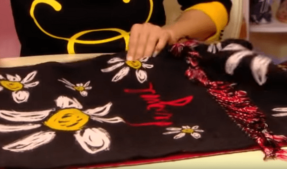 Forming the overlap in a black floral stole with fringe