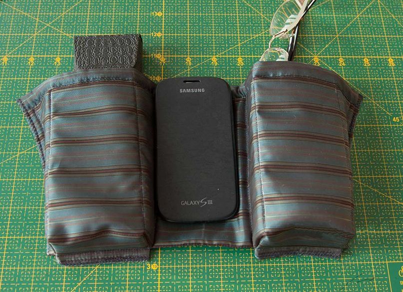 Layout of interior bag compartments beside a phone