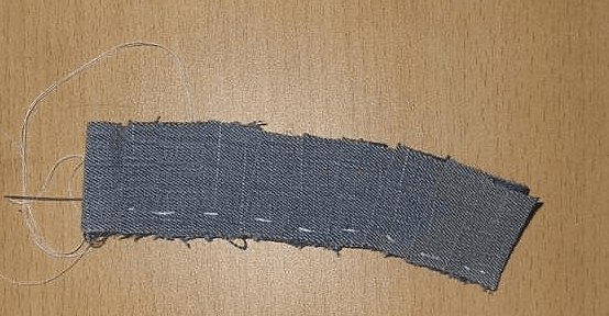 Basting and gathering a denim strip to make a ruffle