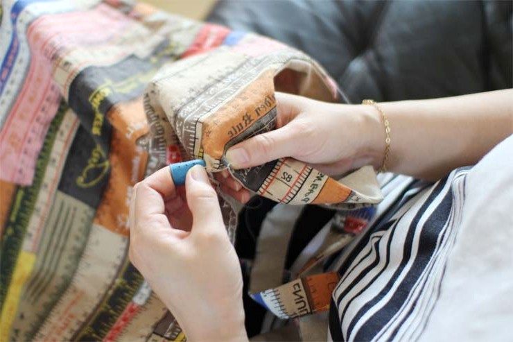 Hand-sewing a snap or closure to a shoulder bag
