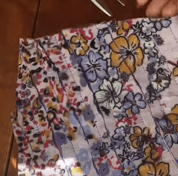 Parallel rows of stitching on the scarf fabric before slashing the layers