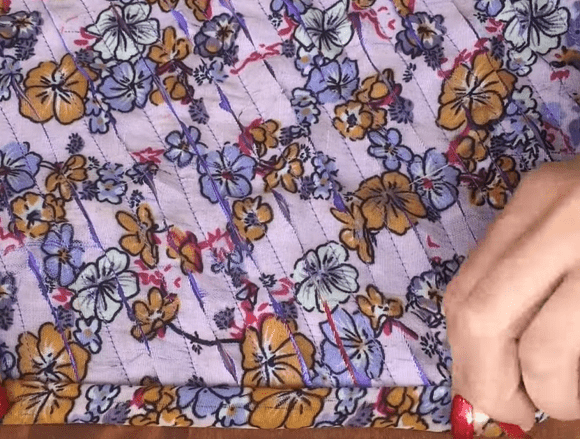 Floral print scarf fabric with closely spaced parallel rows of stitching