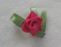 Small rose made from narrow ribbon with green leaves