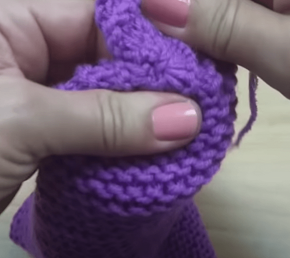 Shaped toe of a seamless footie slipper before joining the top