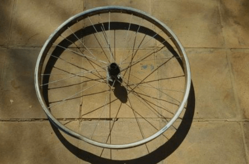 Old bicycle wheel on a tiled floor