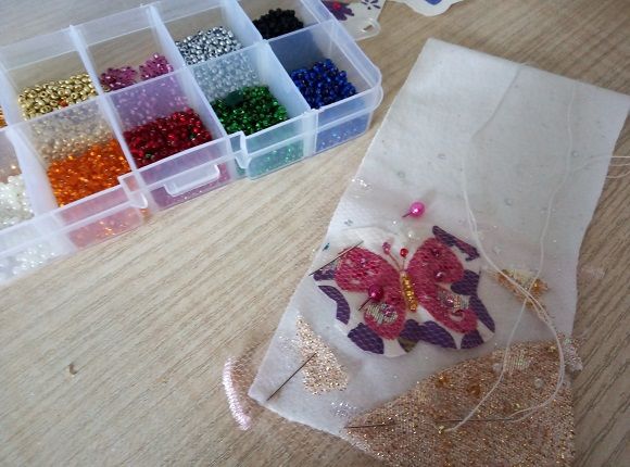 Preparing a fabric pincushion with applique and beads