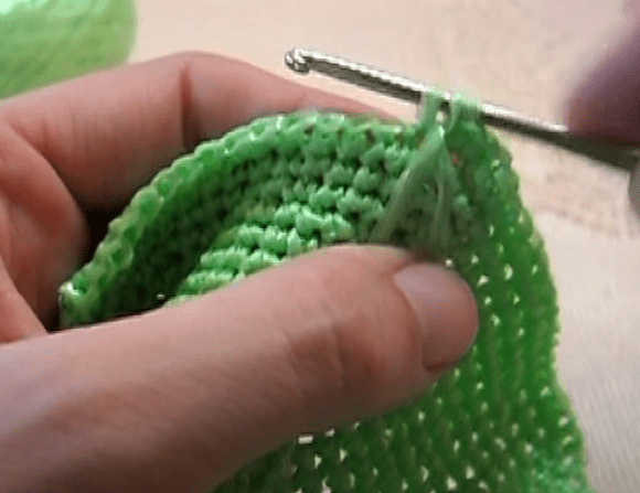 Inserting the crochet hook under a row to make elongated loops