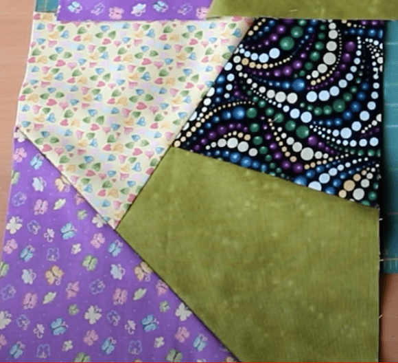 Patchwork mosaic in green, purple, and light fabrics