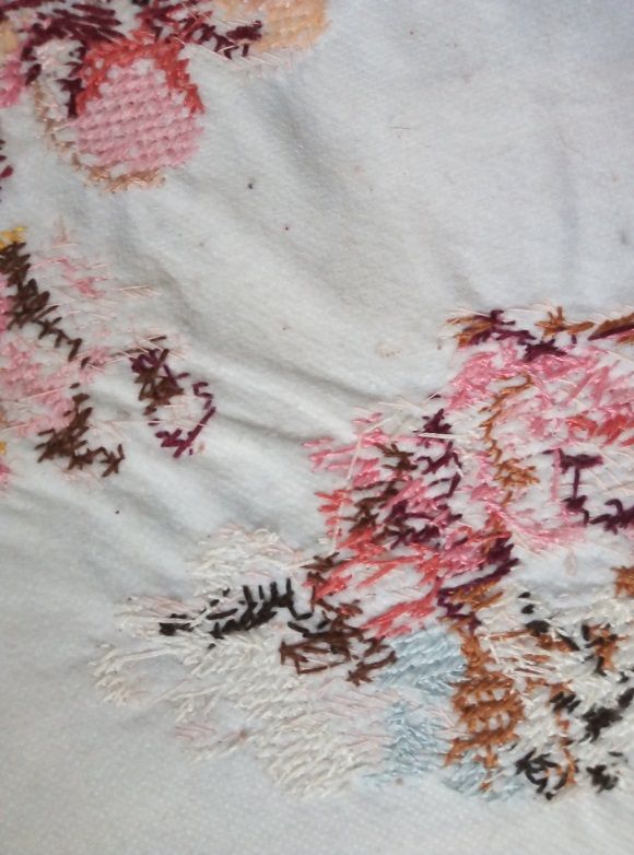 Close-up of puckered fabric on the damaged embroidery