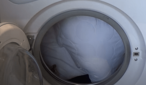 A clean, white pillow on a bed