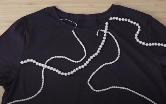Beads arranged on a black T-shirt