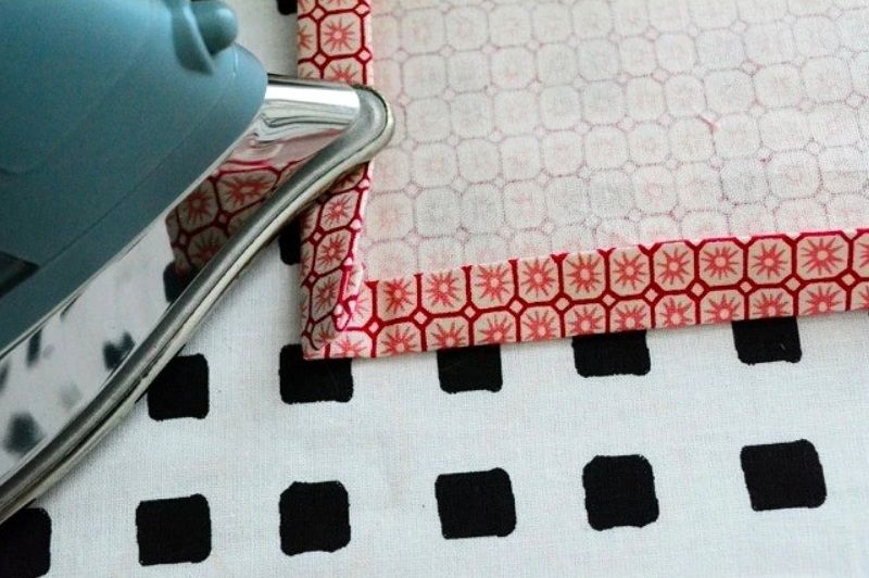 Pressing a hem fold on the corner of a napkin