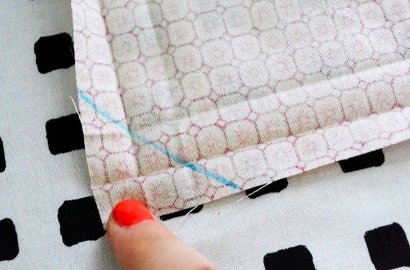 Blue diagonal markings on the wrong side of a fabric corner