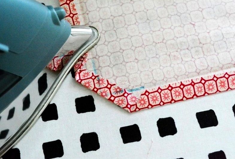 Pressing a folded fabric corner