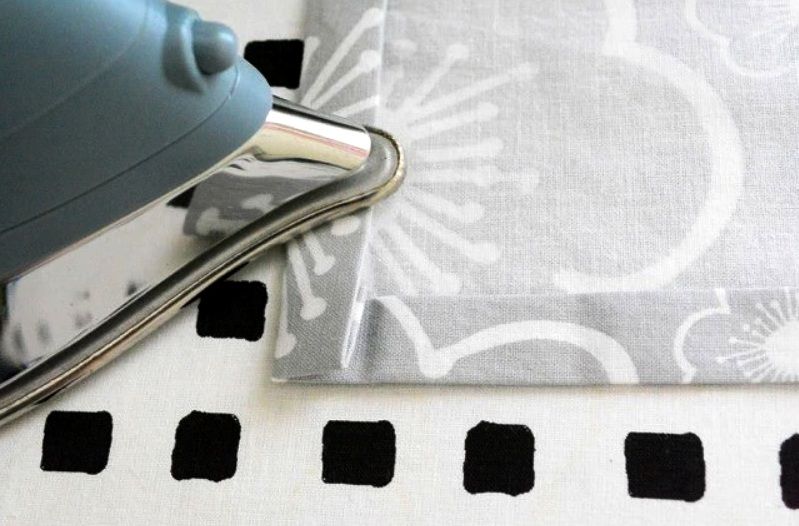 Pressing a corner on gray fabric