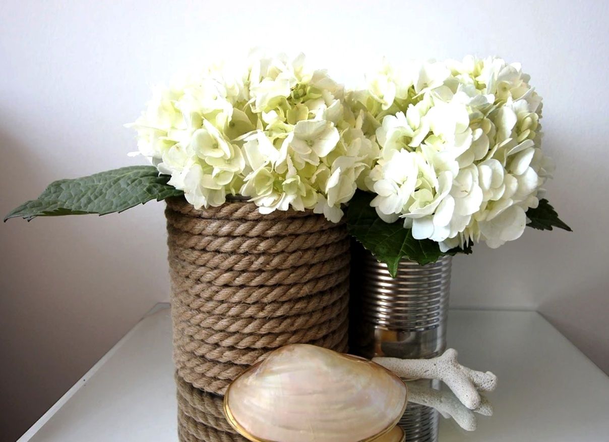 Glass jar and tin can wrapped with rope and used as flower vases