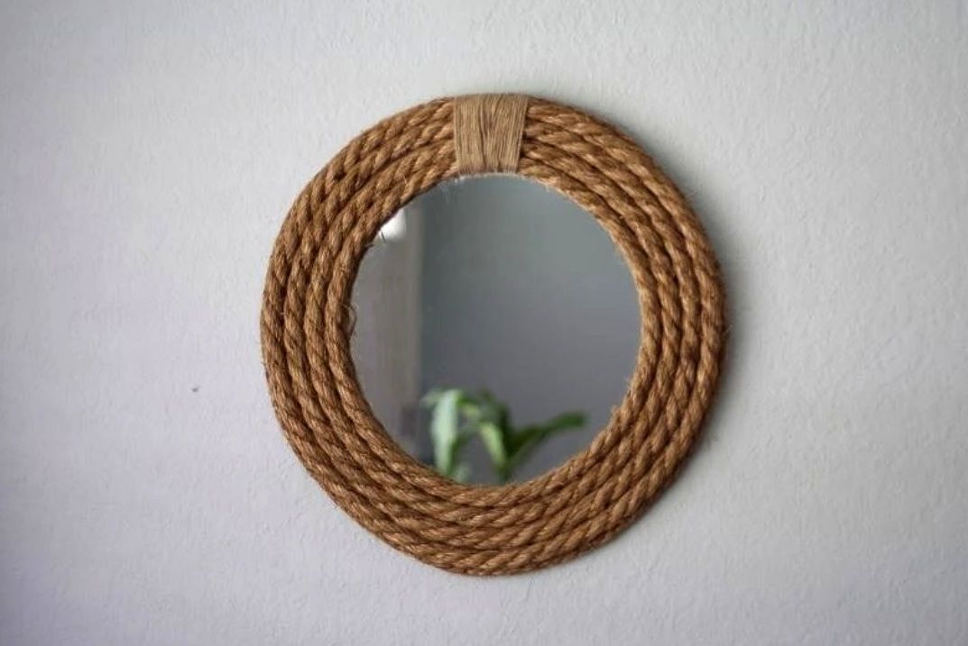Round wall mirror framed with thick coiled rope