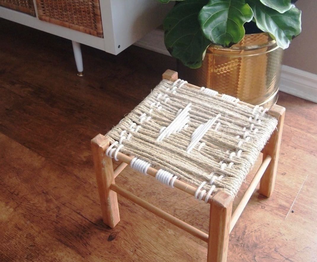Finished wooden stool with a geometric white cord pattern
