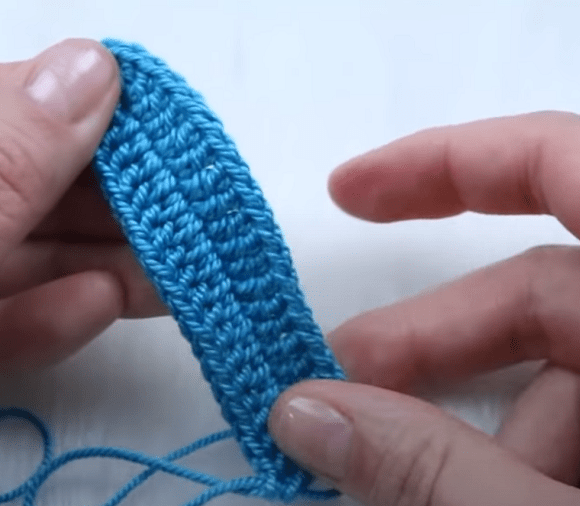 First row of a crochet cup worked around the central chain